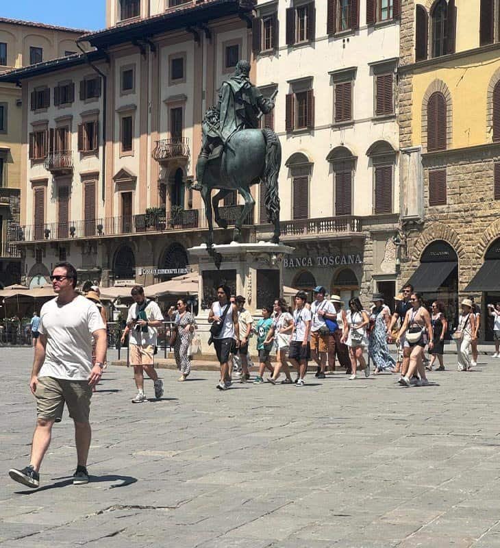 ourists walking in Piazza della Signoria, Florence, near the equestrian statue of Cosimo I de' Medici