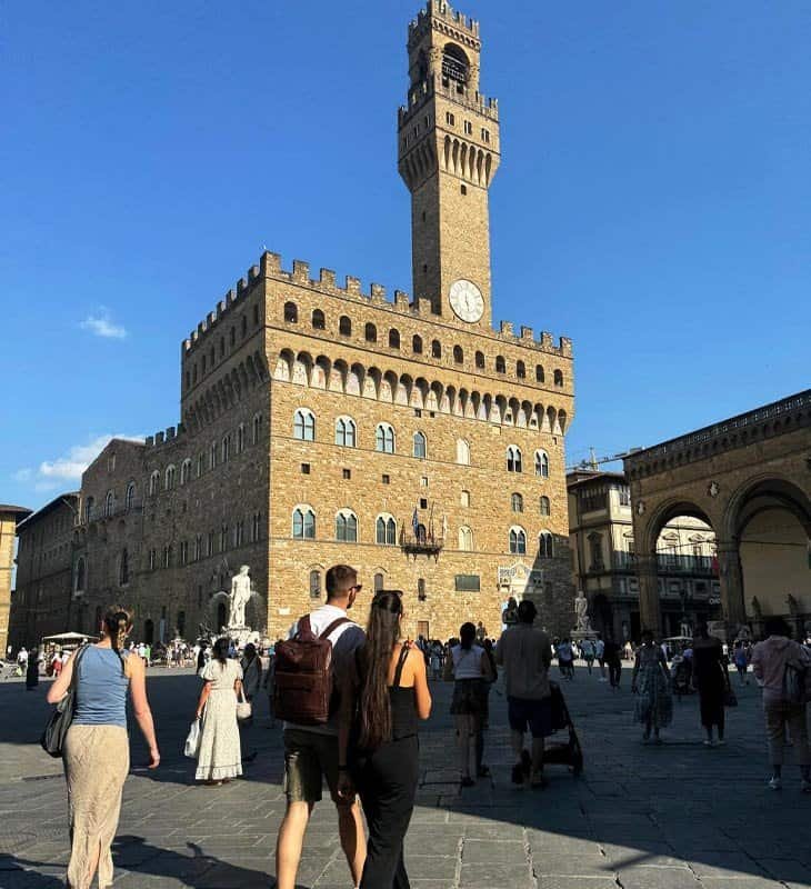 People gathered in front of Palazzo Vecchio in Florence’s Piazza della Signoria on a sunny afternoon